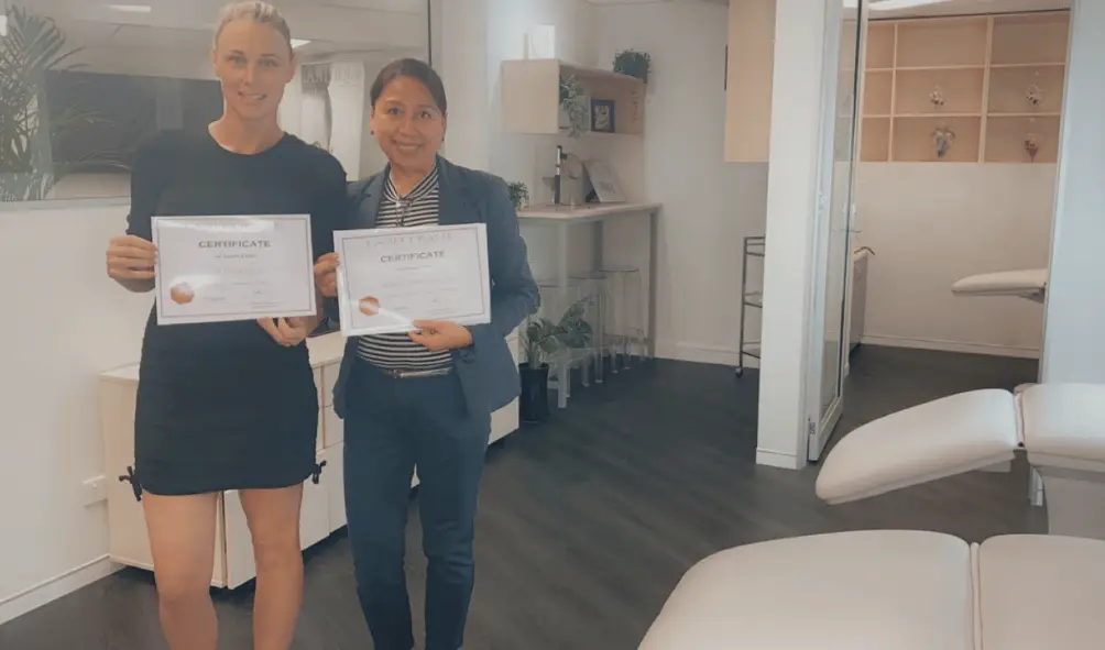 Lash students with certificates after completing professional training in Brisbane