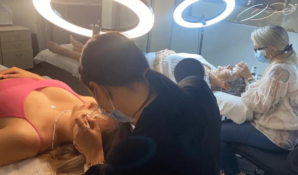 Hands on lash extension training Brisbane students working on models